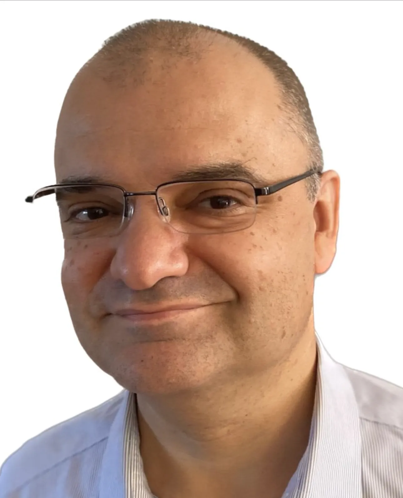 Close-up of a smiling middle-aged man wearing glasses and a light-colored collared shirt against a white background.